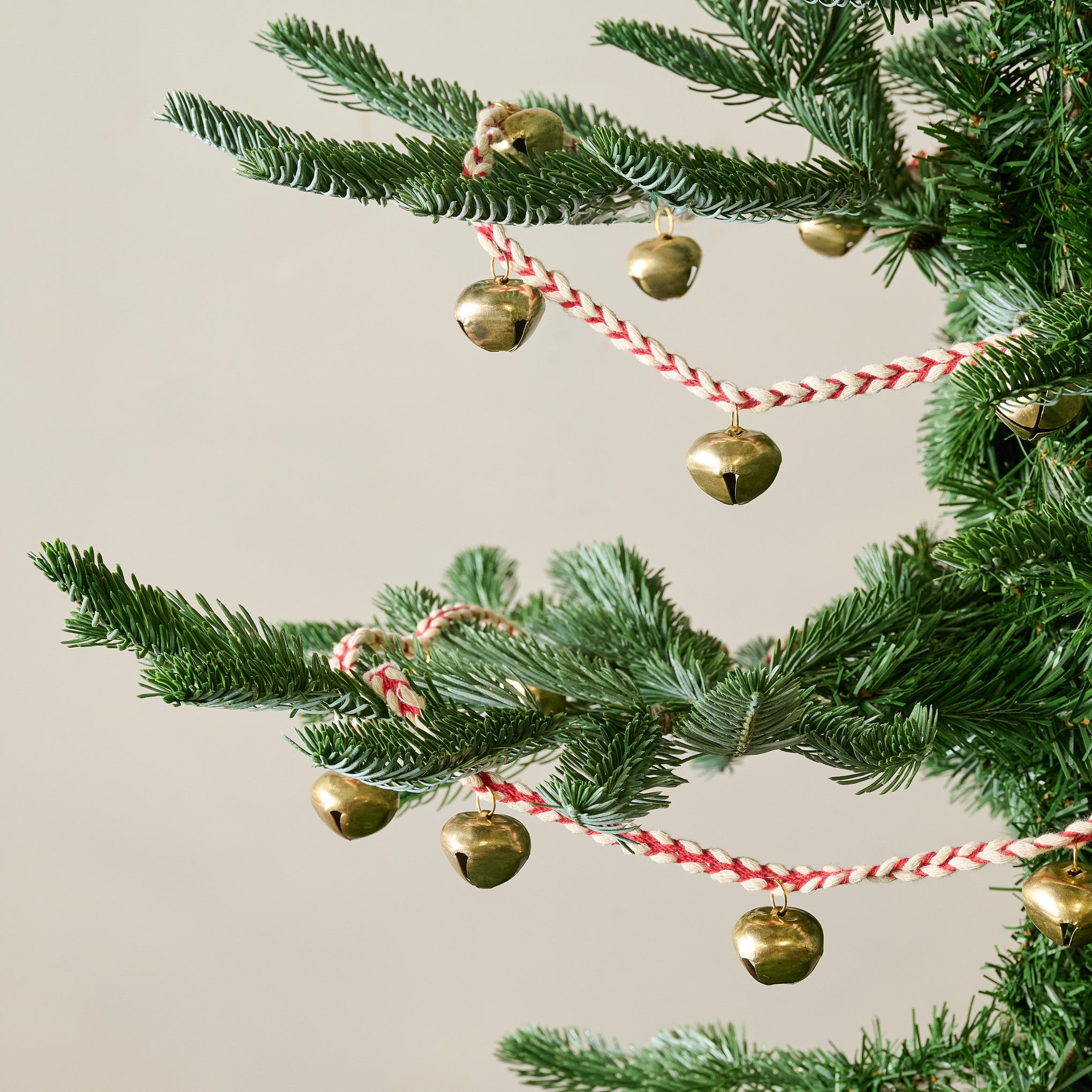 Jingle Bell Garland shown on tree On sale for $9.99, discounted from $24.00