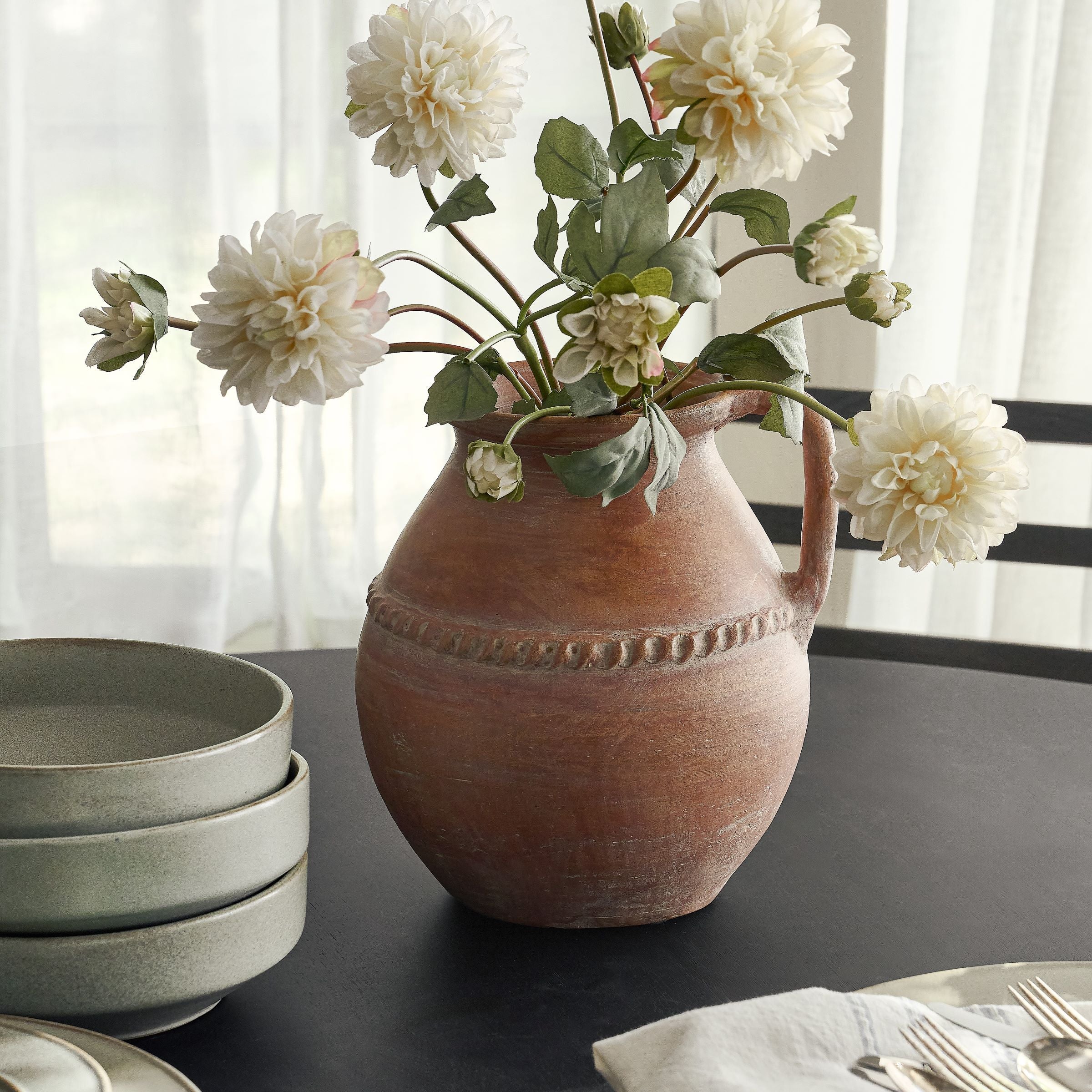 Camila Rust Terracotta Vase with white faux dahlia stem set on dining table $68.00