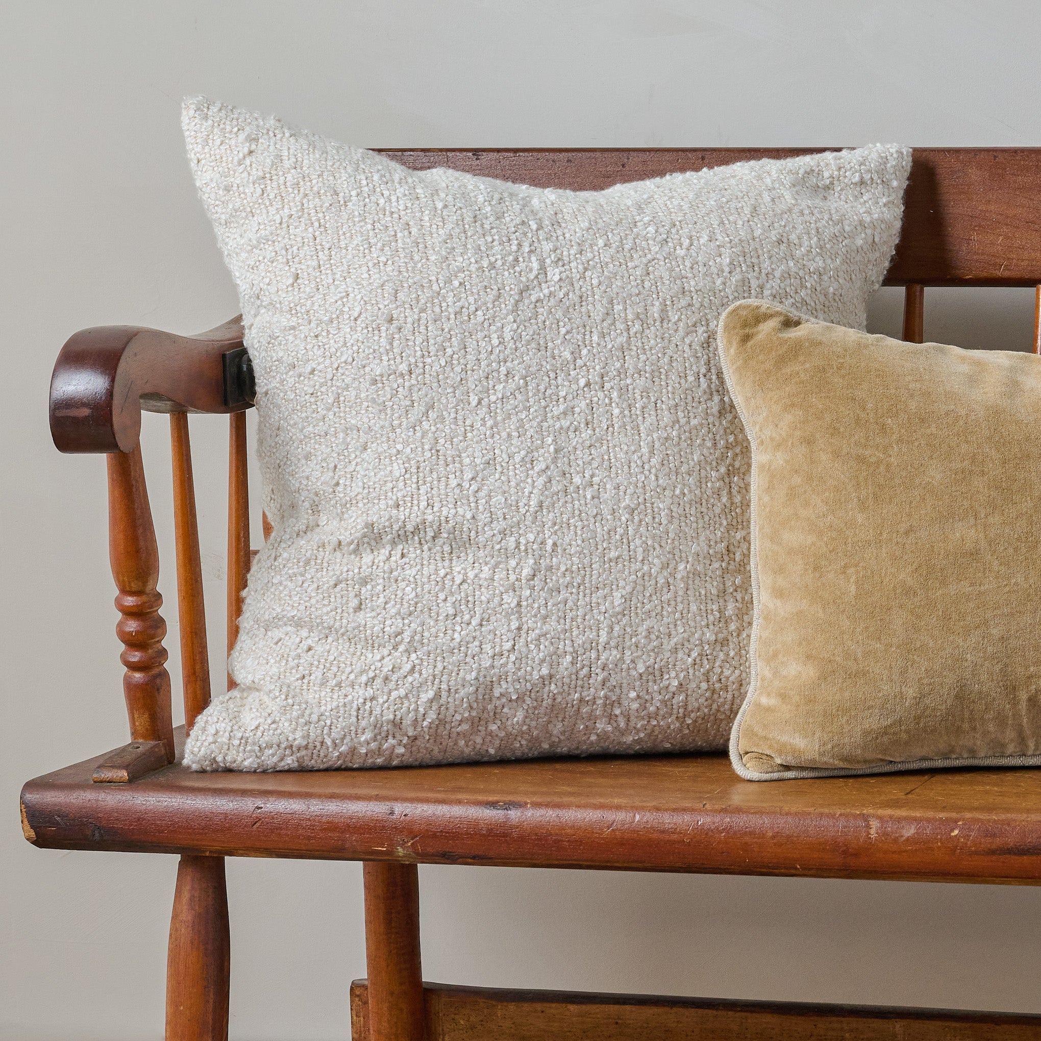 Teddy Pillow shown on bench with yellow velvet pillow On sale for $73.50, discounted from $98.00