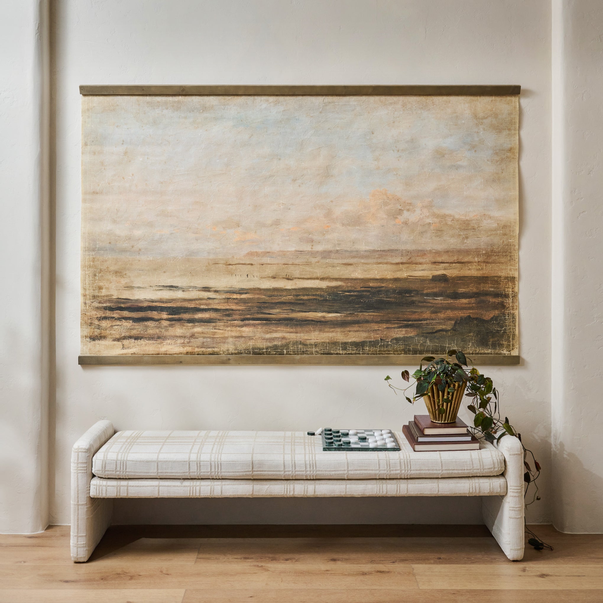 Oversized Hues of Dusk Tapestry shown hung above bench