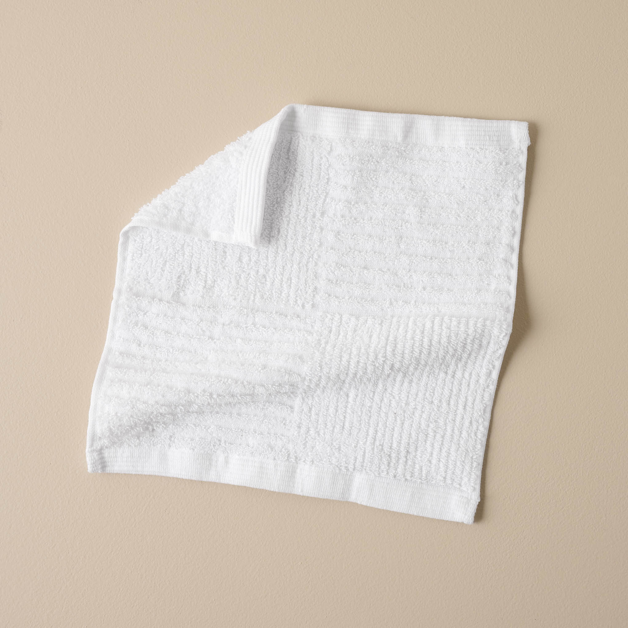 folded white textured bath washcloth