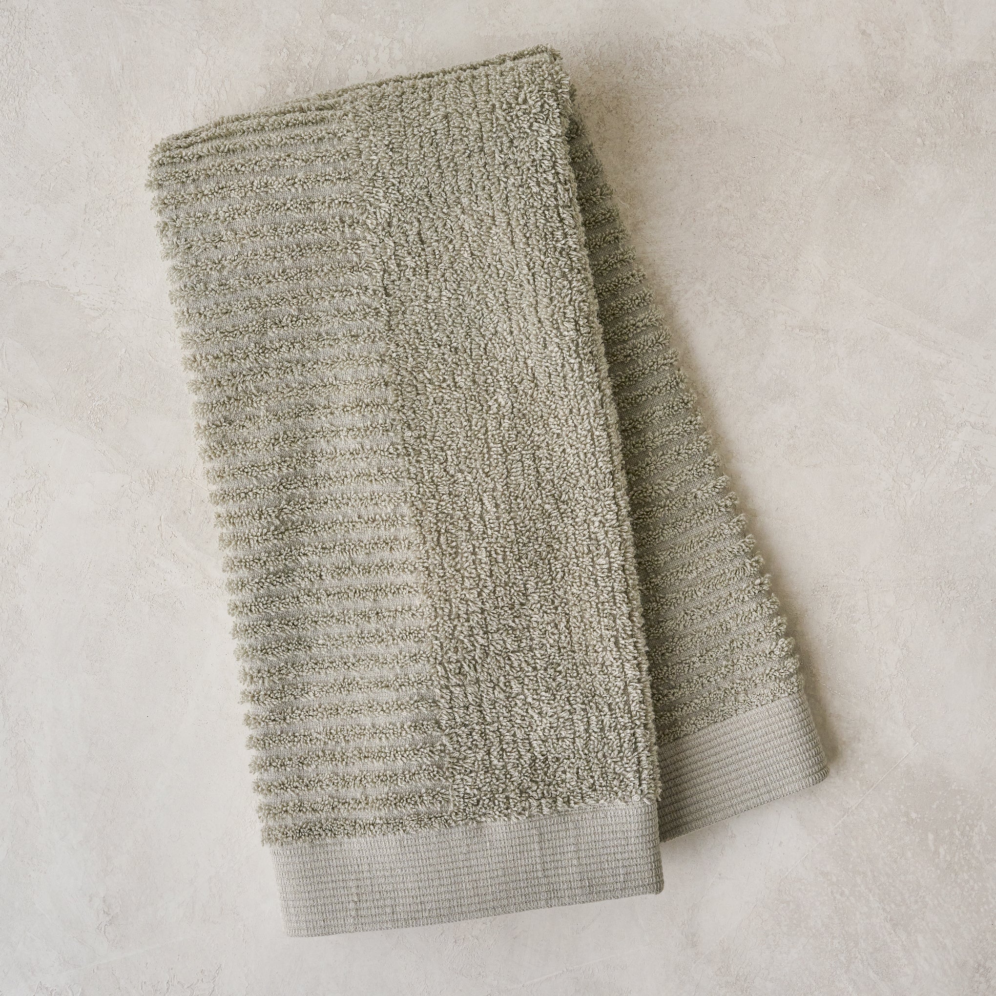 folded eucalyptus green textured hand towel