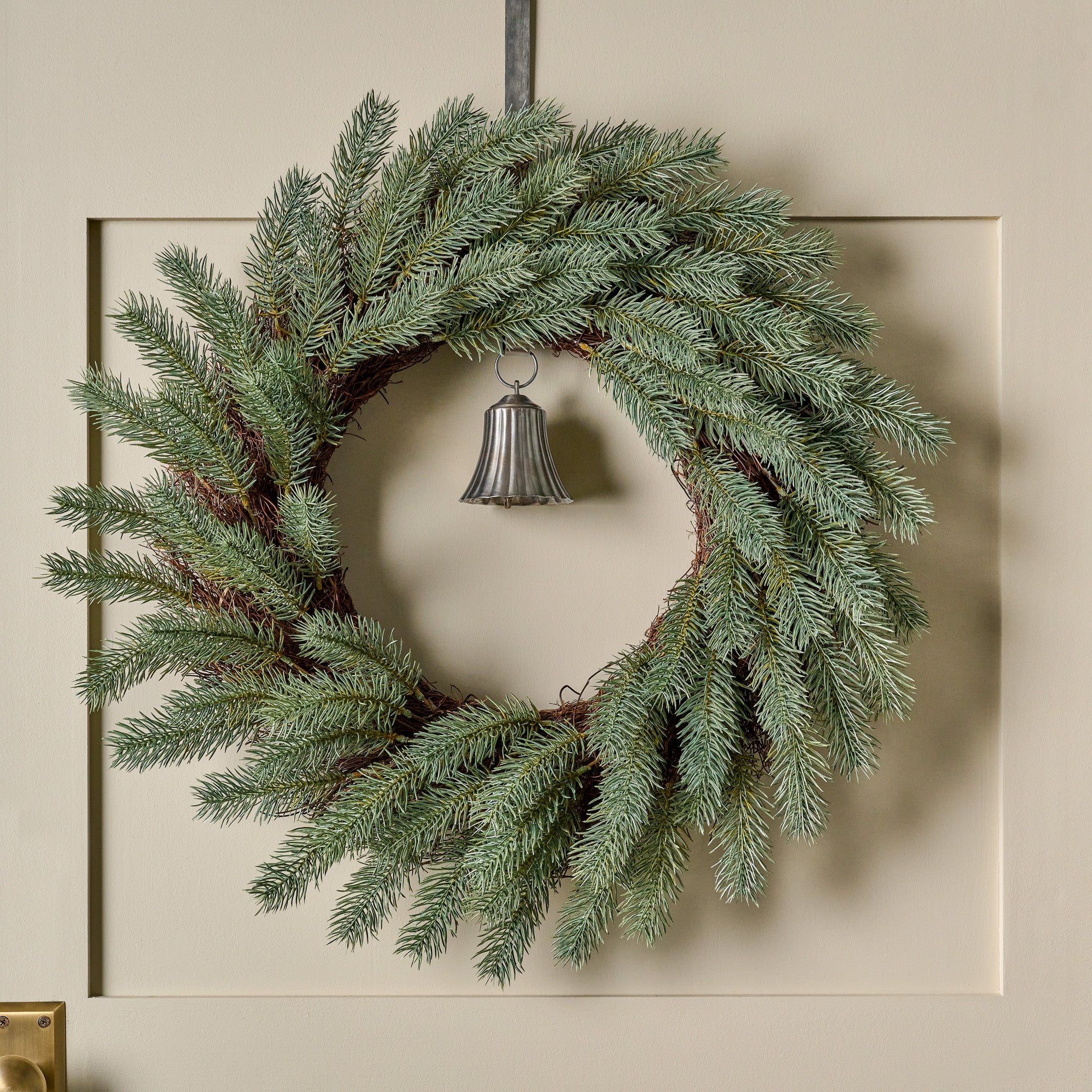 Real Touch Silver Pine Wreath shown hung on door with bell On sale for $29.99, discounted from $98.00