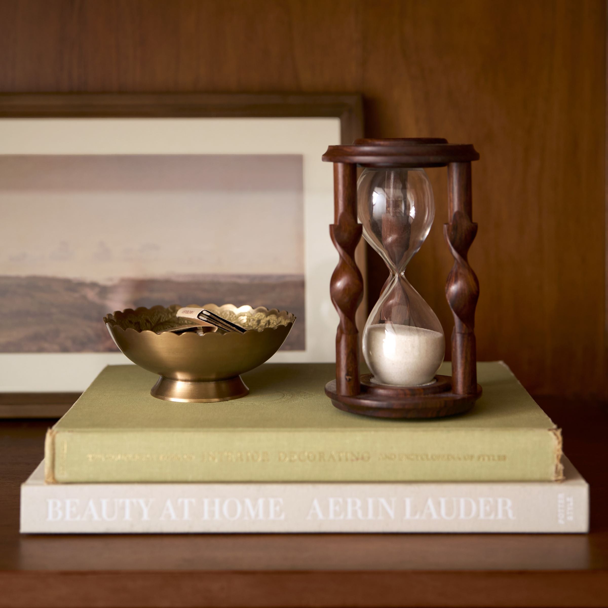 Barley Twist Hourglass set on stack of books next to brass bowl $36.00
