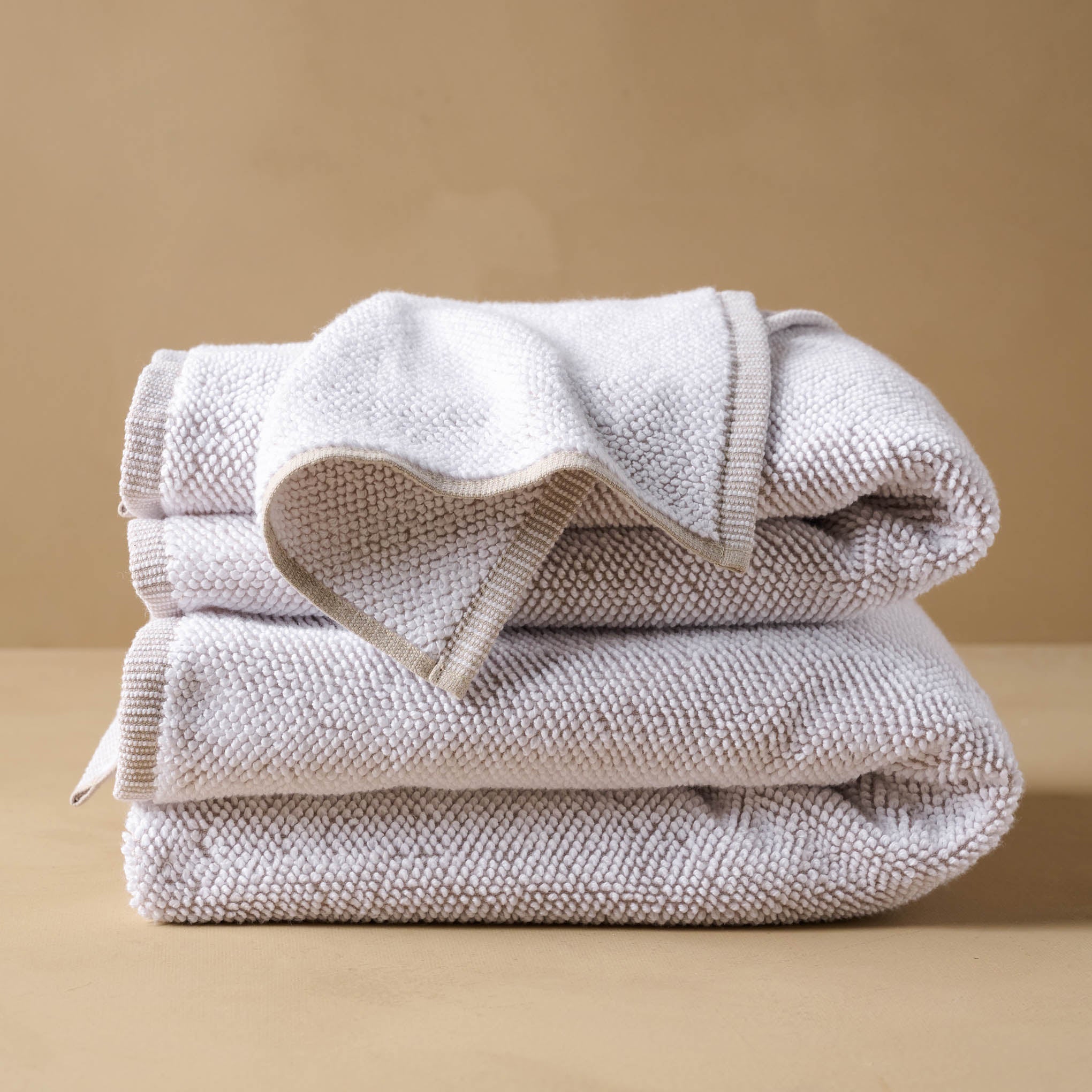 Linen Assisi Textured Towel folded with wash cloth draped on top On sale for $9.99, discounted from $14.00