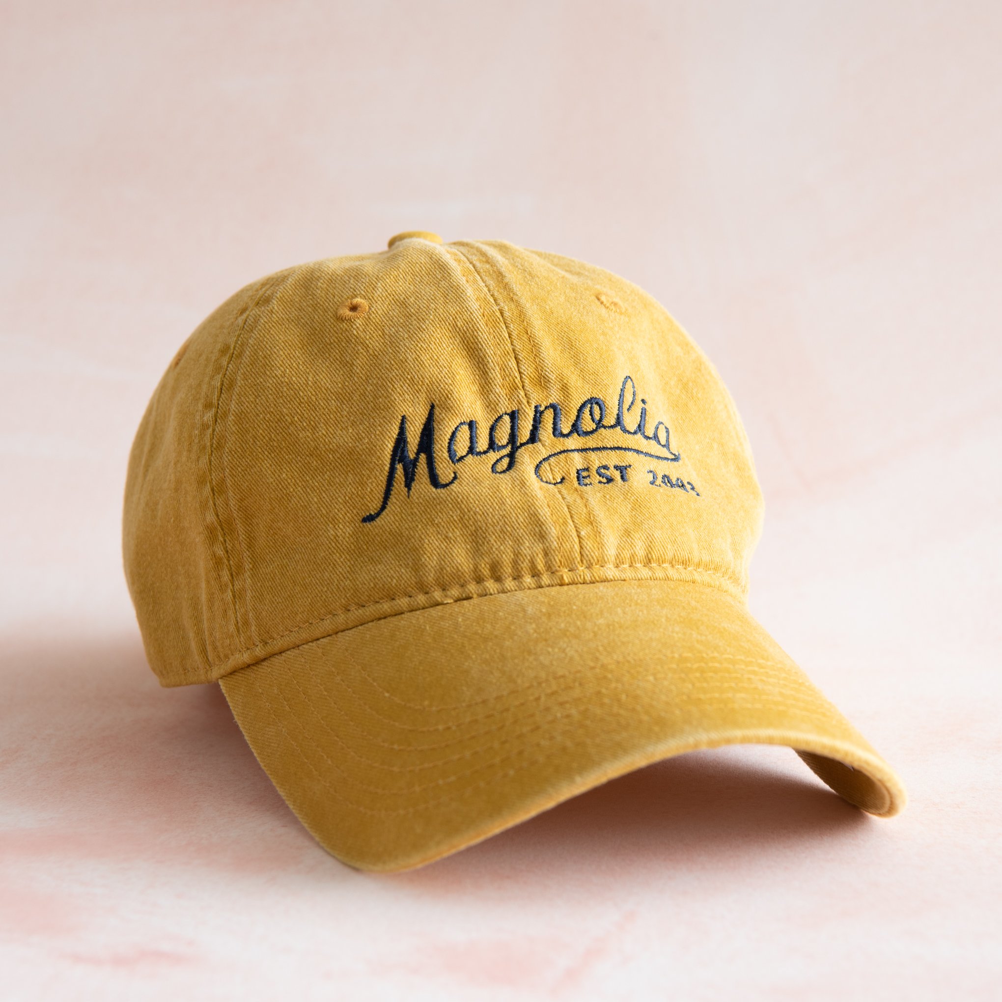 yellow ball cap with "Magnolia Est 2003" in cursive script $34.00