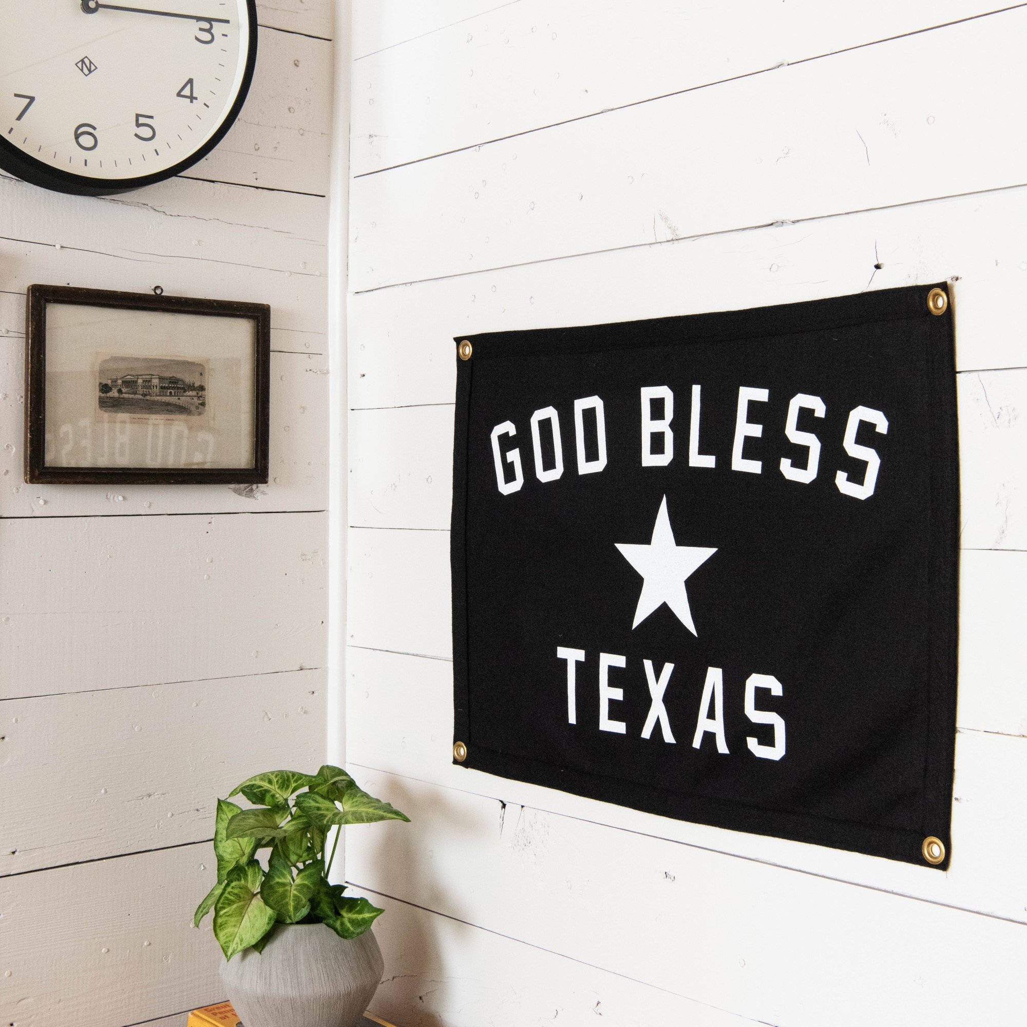 black decorative flag that says "god bless texas" with a star in the center