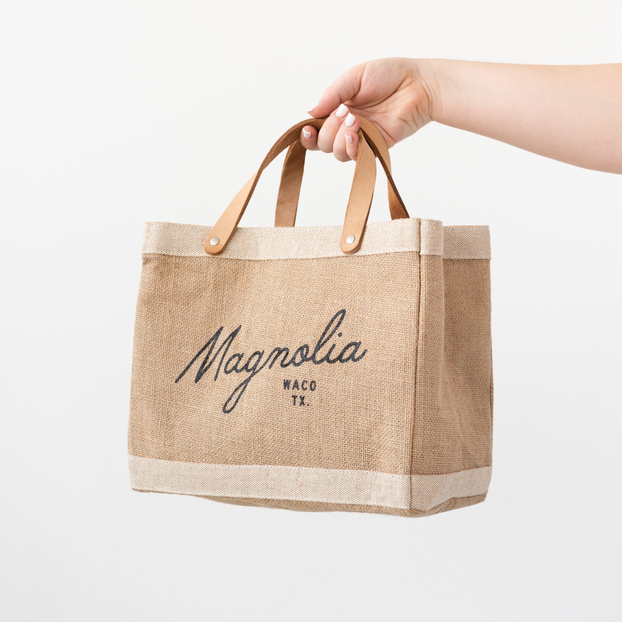 burlap tote with leather handles with Magnolia script logo $48.00
