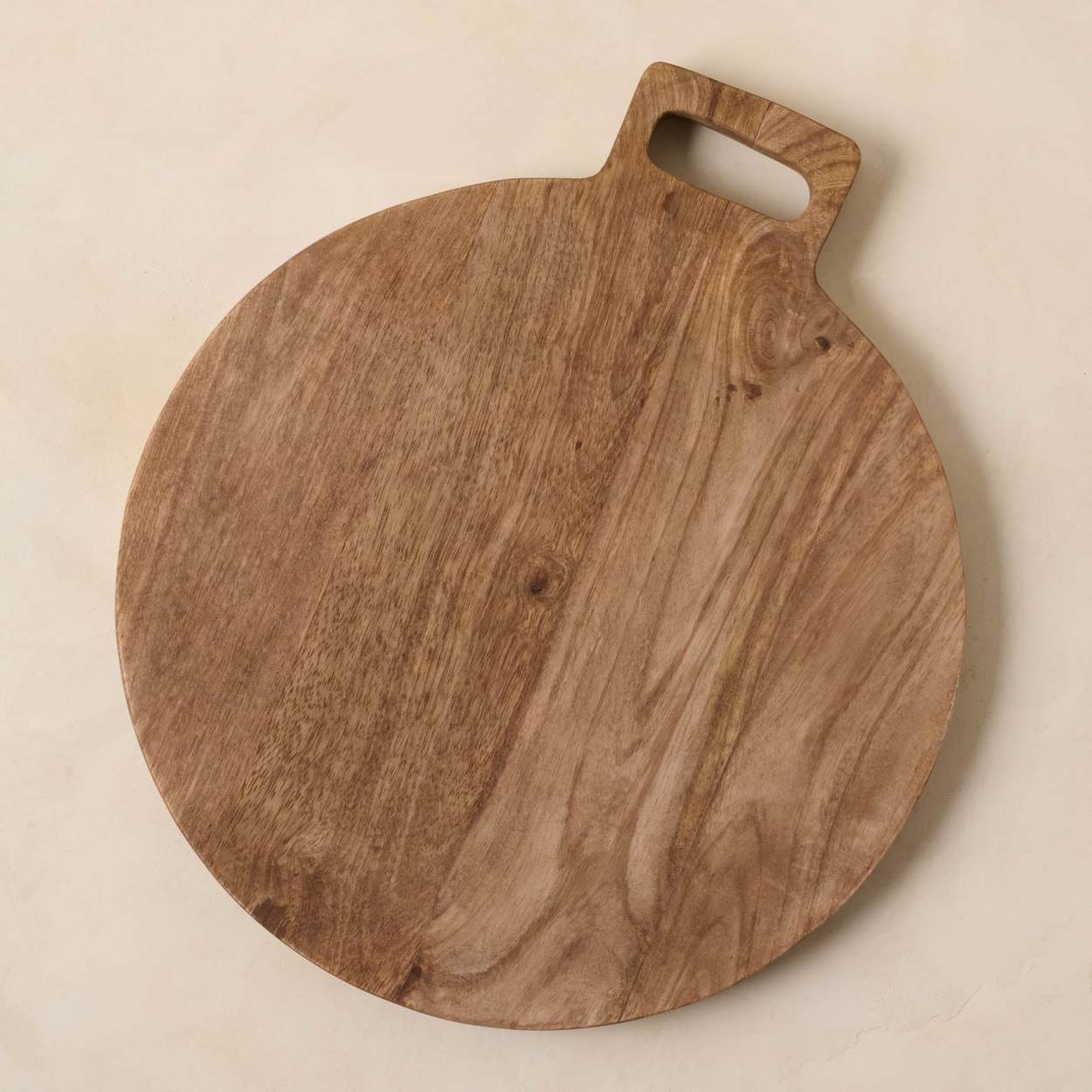 Vintage wooden cutting board on top of black stone kitchen stone