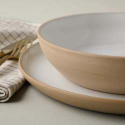 Stone White Lakelynn Pasta Bowl on top of a dinner plate