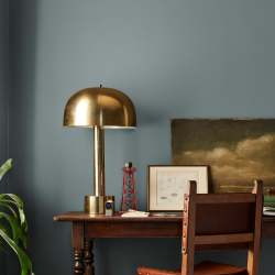 deep muted blue with grey undertones paint named duke gray shown painted on bedroom wall