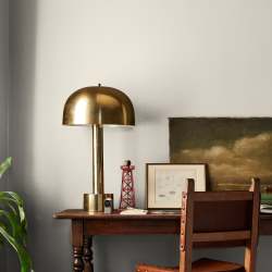Warm beige interior paint named blanched shown painted on bedroom wall