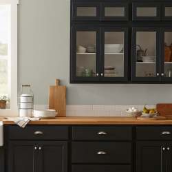 Warm chalky pale green interior paint named flower jar shown painted on kitchen wall