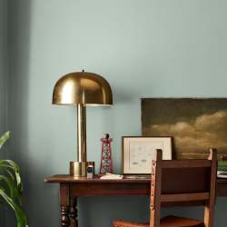 Creamy mint green interior paint named freshly cut stems shown painted on bedroom wall