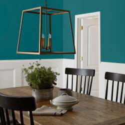 A deep peacock blue interior paint named under the stars shown painted on dining room wall