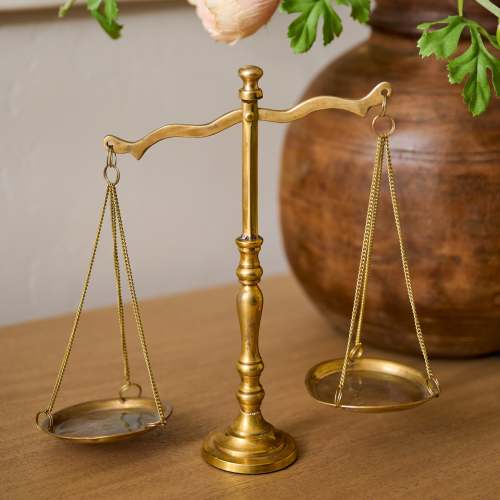 Solid Brass Bookshelf Scale shown on table On sale for $30.40, discounted from $38.00