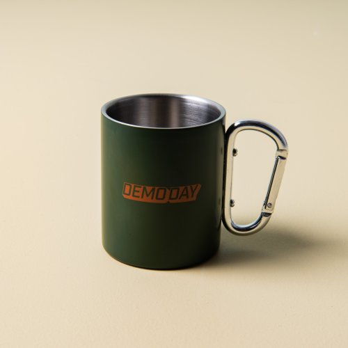green stainless steel mug with "demoday" printed on the side with silver carabiner handle On sale for $9.60, discounted from $12.00