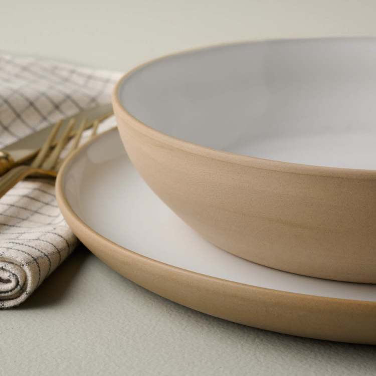 Stone White Lakelynn Pasta Bowl on top of a dinner plate