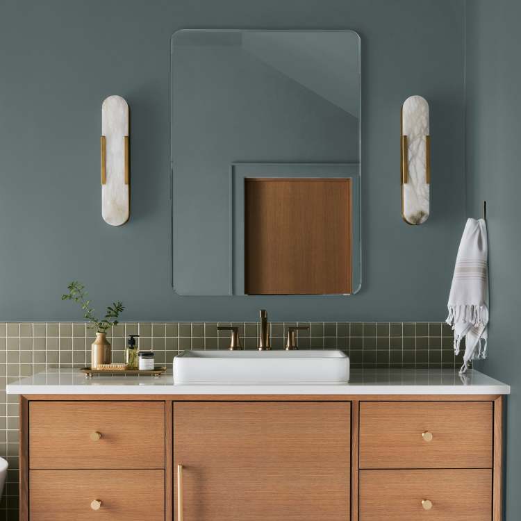 deep muted blue with grey undertones paint named duke gray shown painted on bathroom wall