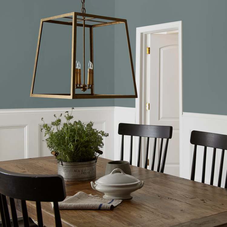 deep muted blue with grey undertones paint named duke gray shown painted on dining room wall