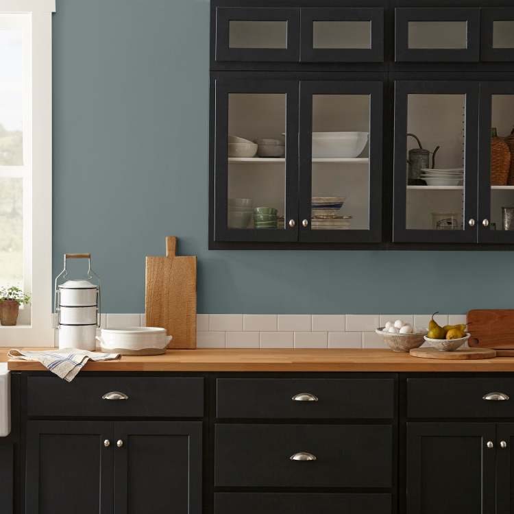 deep muted blue with grey undertones paint named duke gray shown painted on kitchen wall