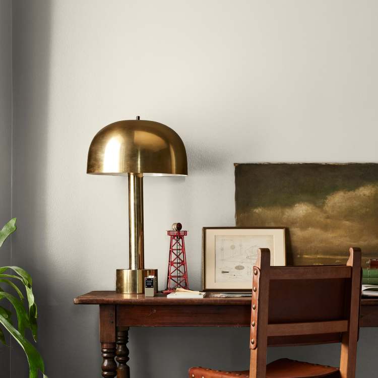Warm beige interior paint named blanched shown painted on bedroom wall