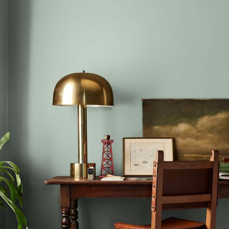 Creamy mint green interior paint named freshly cut stems shown painted on bedroom wall