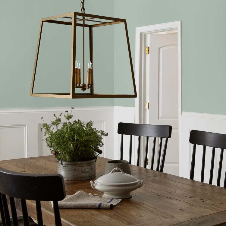 Creamy mint green interior paint named freshly cut stems shown painted on dining room wall