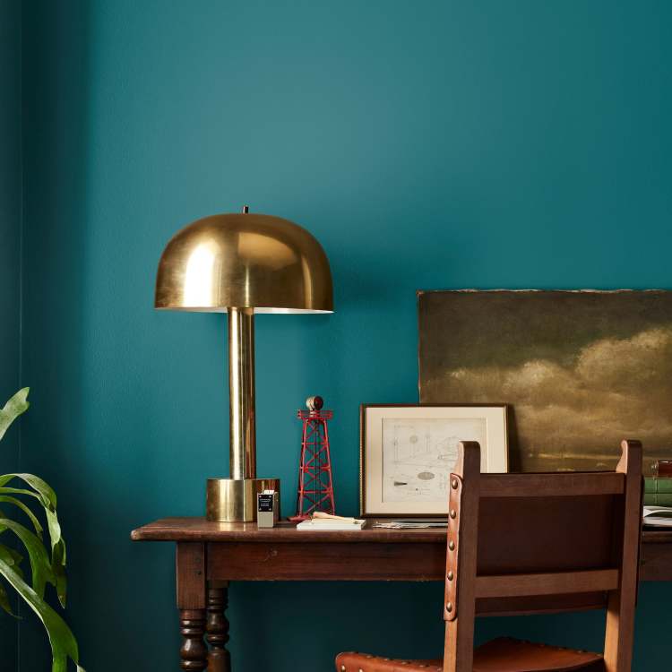 A deep peacock blue interior paint named under the stars shown painted on bedroom wall