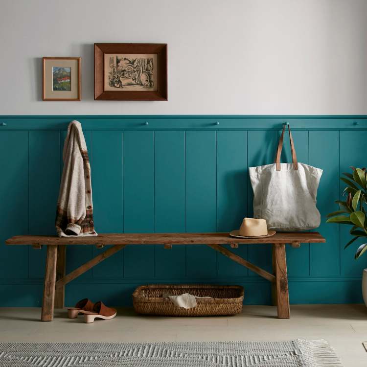 A deep peacock blue interior paint named under the stars shown painted on entryway wall